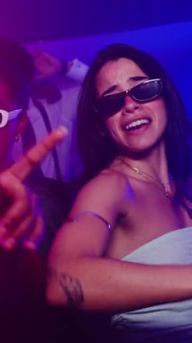 Gece kulübünde dans eden genç kadınlar, müzik ve gece hayatını canlı, yavaş çekim montajında seviyorlar.