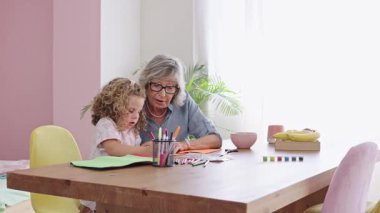 Sevgi dolu büyükanne torununun resim çizmesine yardımcı olur. İnsanın içini ısıtan bir bağ kurma ve öğrenme anı yaratır.