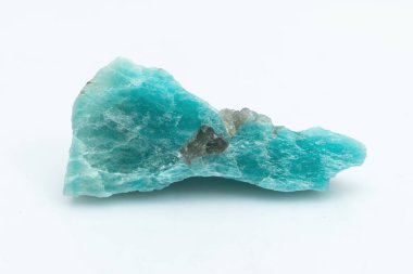 Beyaz arka planda izole edilmiş doğal Amazon mücevheri. Arka planda mavimsi yeşil bir kristal. Potasyum feldspat mikro-cline çeşitleri