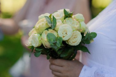Gelinin elinde bir buket çiçek. Bir buket beyaz çiçek bir kadının ellerinde..