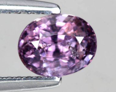 Gri arkaplanda doğal mor ametist taşı.