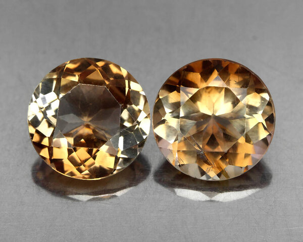 Beautiful natural stone imperial topaz on a gray background