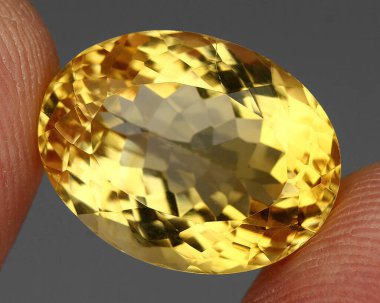 Natural gem yellow citrine on gray background