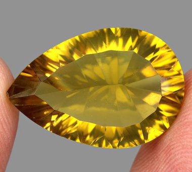 Natural gem yellow citrine on gray background