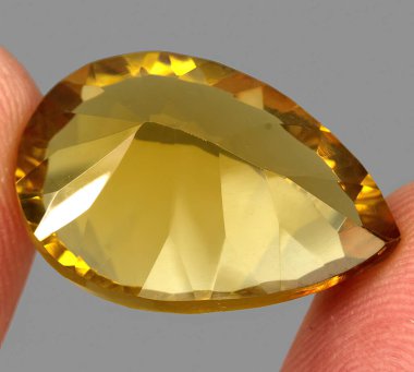 Natural gem yellow citrine on gray background