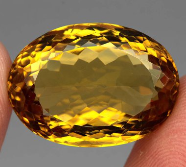 Natural gem yellow citrine on gray background