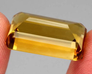 Natural gem yellow citrine on gray background