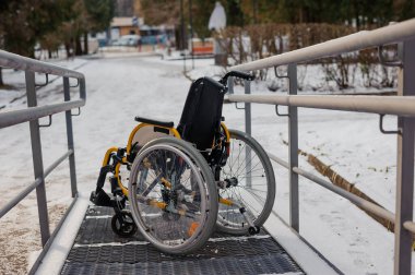 Empty wheelchair in the hospital on the ramp. Wheelchair close-up. Childrens wheelchair.