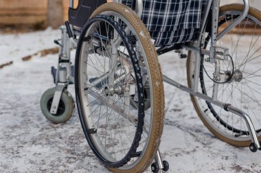 Empty wheelchair in the hospital on the ramp. Wheelchair close-up. Childrens wheelchair.