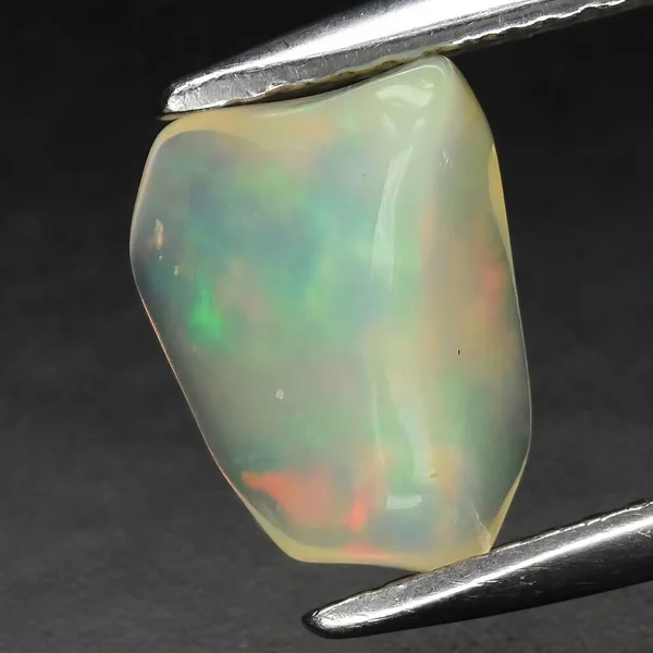 Natural precious stone opal on a black background
