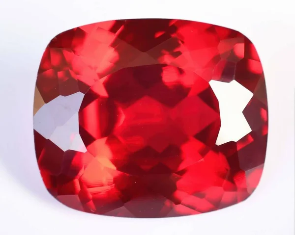 Natural gem red ruby on gray background