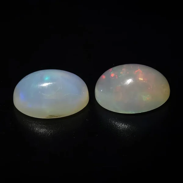 Natural precious stone opal on a black background
