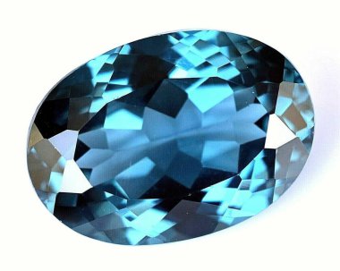 Natural gem blue spinel on a gray background clipart