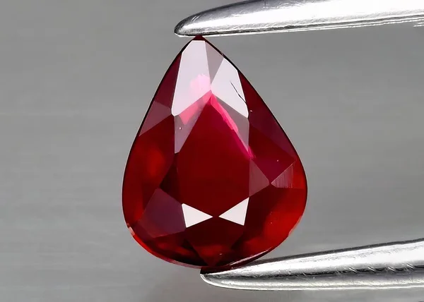 Natural gemstone red ruby on gray background