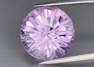 Natural gem purple amethyst on gray background