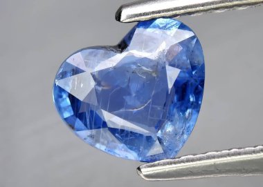 Natural gem blue sapphire on gray background