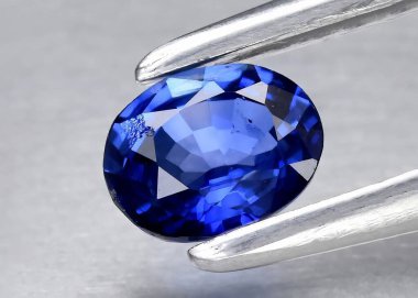 Natural gem blue sapphire on gray background