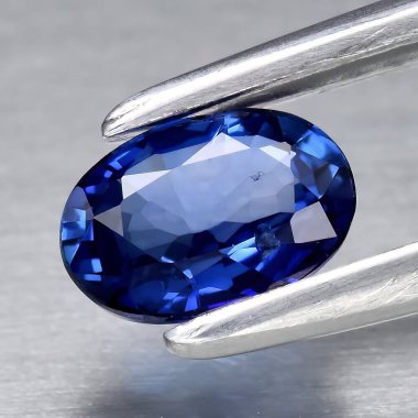 Natural gem blue sapphire on gray background