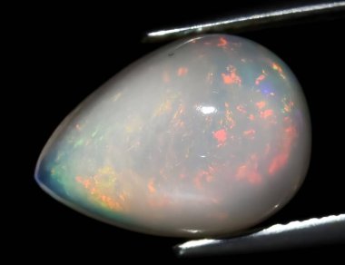Natural precious stone noble opal on a black background clipart