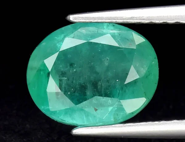 Natural gem green emerald on black background
