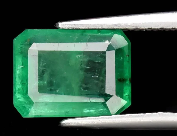 Natural gem green emerald on black background