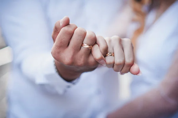 新婚夫妇手里拿着结婚戒指 一男一女手上的金戒指 — 图库照片