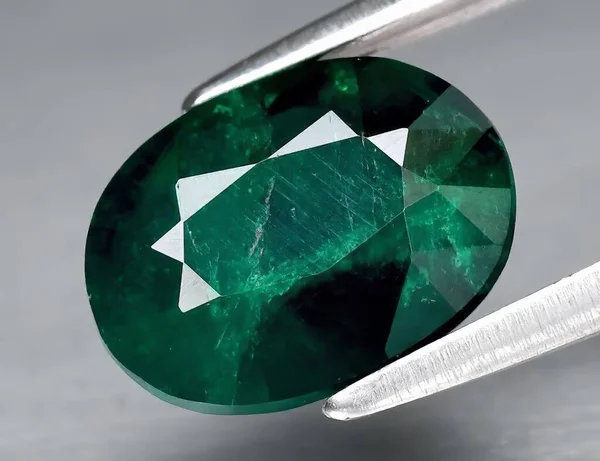 Natural gem green dioptase on a gray background