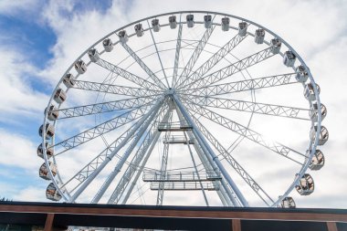 Bukovel 'de mavi gökyüzünün önünde büyük, uzun, beyaz dönme dolap. Karpatlar