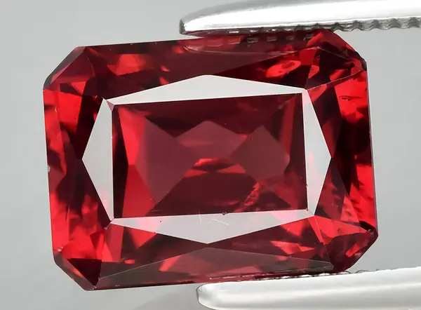 natural red rhodolite gem on the background