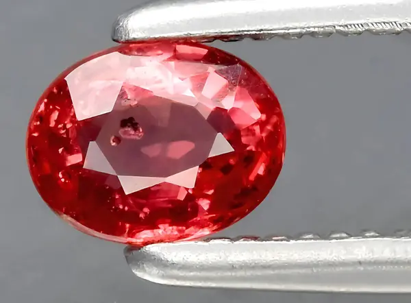 natural bright red sapphire gem on background