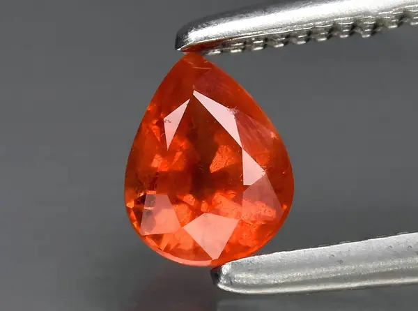 stock image natural orange padparadscha sapphire gem on background