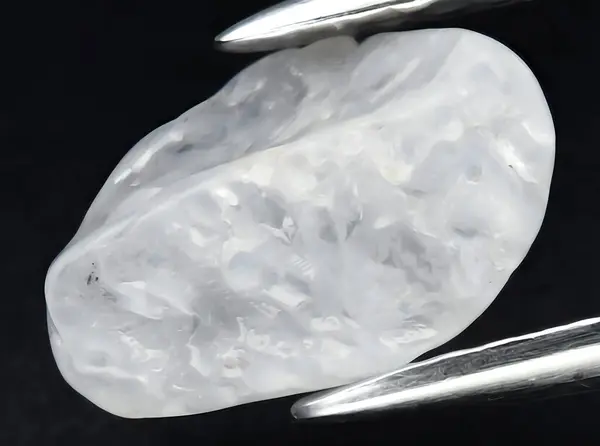natural white sapphire rough gem on background