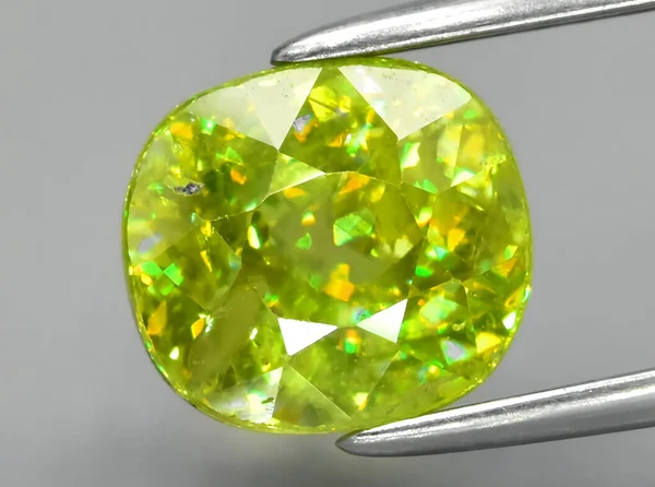 natural green sphene gem on background