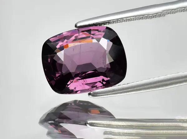 natural purple spinel gem on background