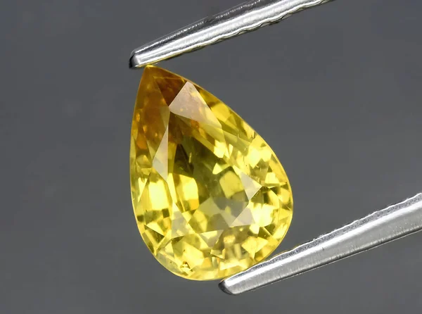 Stock image natural yellow chrysoberyl gem on background