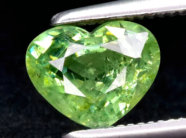 natural green demantoid garnet gem on background