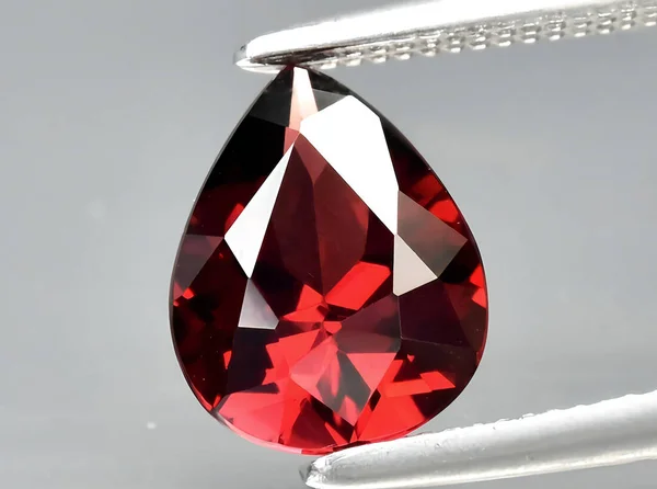 natural red garnet gem on background