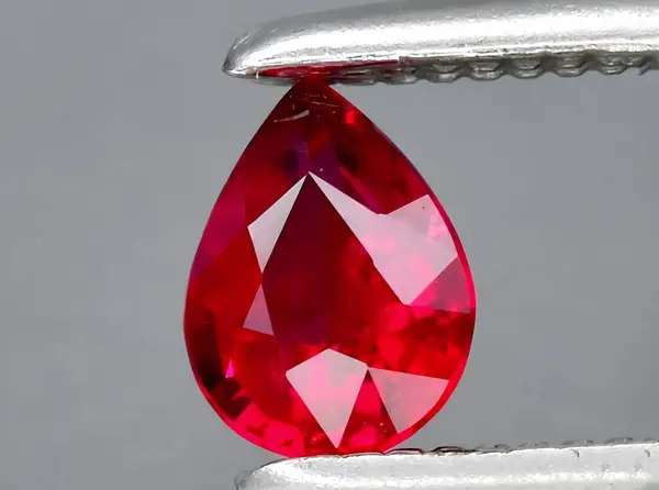 natural red ruby gem on background