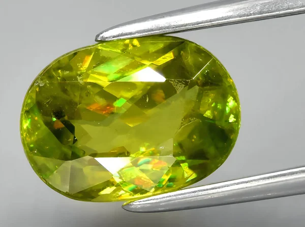 natural green sphene titanite gem on background
