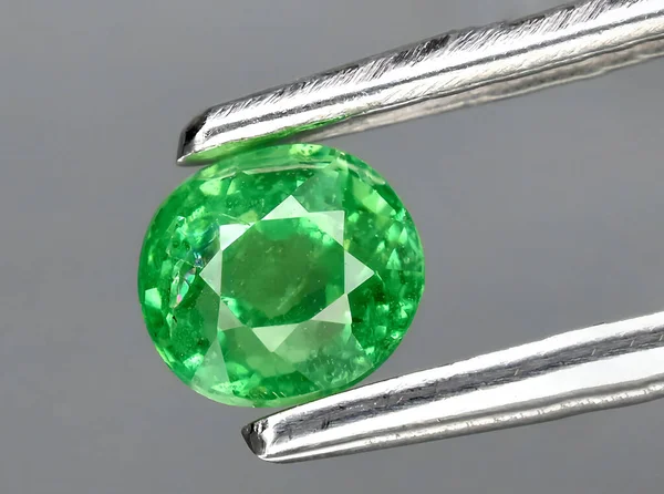 natural green tsavorite garnet gem on background