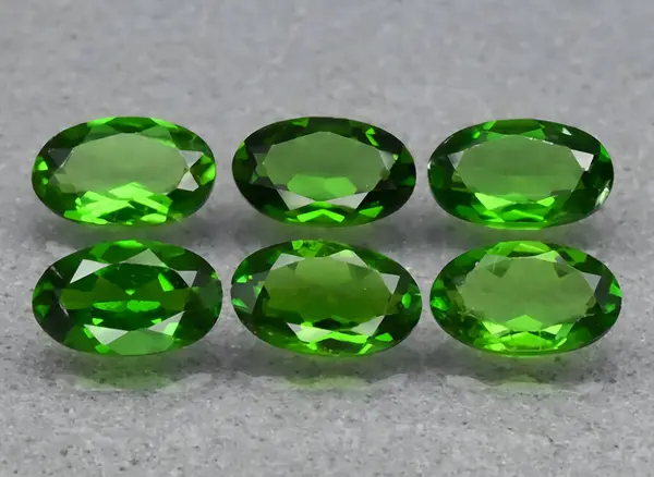 natural green chrome diopside gem on background