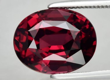 Natural pink red rhodolite garnet gem on background clipart