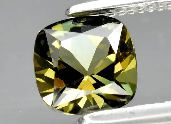 Natural green kornerupine gem on background