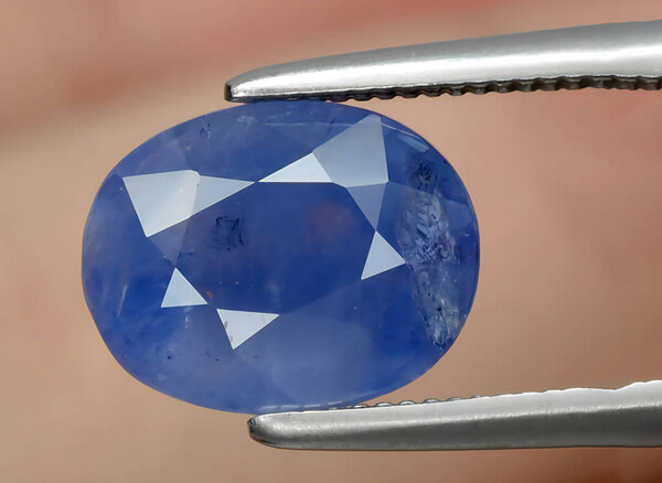 Natural blue sapphire gem on background