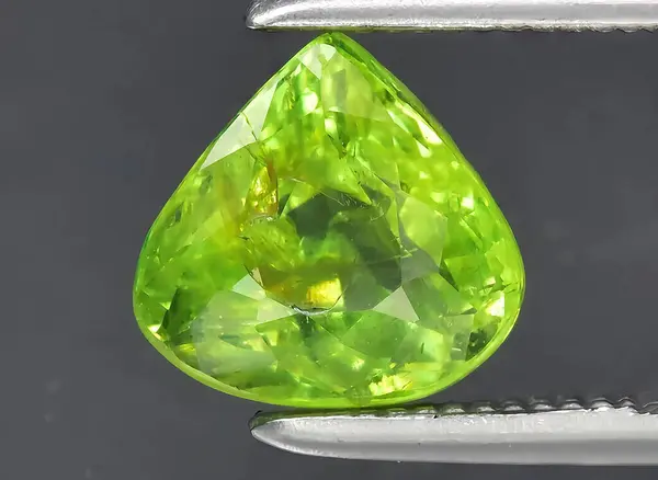 natural green garnet grossular gem on background