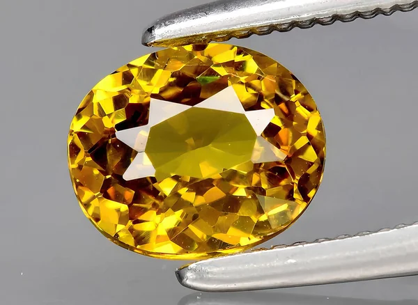 natural yellow grossular gem on background