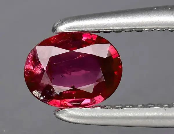 natural red ruby gem on background