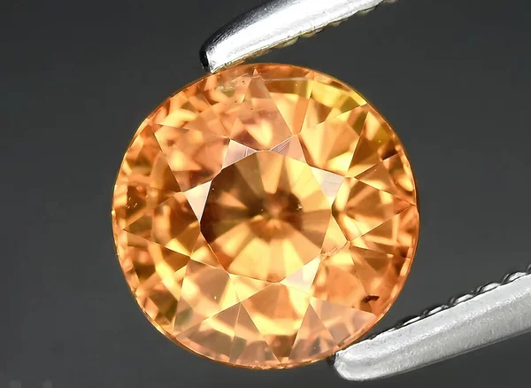 natural orange sapphire gem on background