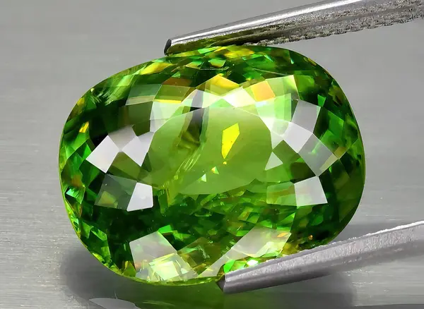natural green sphene gem on background