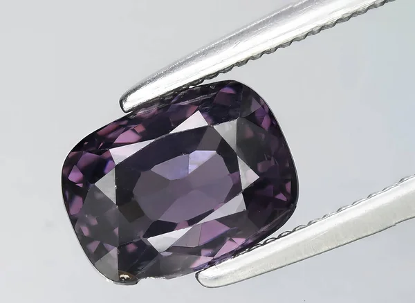 natural purple spinel gem on background